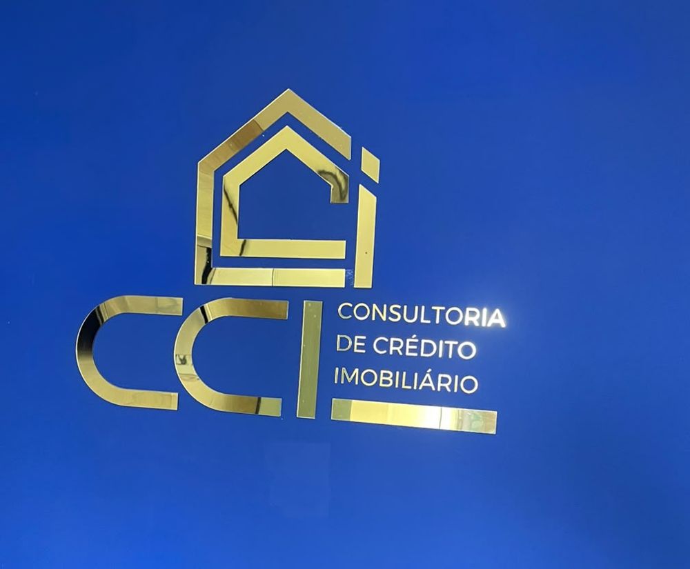 Logo dourada da CCI na parede azul do escritório